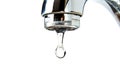 A close-up of a chrome tap with a single water droplet about to fall, set against a white background Royalty Free Stock Photo