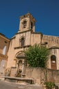 Close-up of church with steeple and flowers, in Lourmarin. Royalty Free Stock Photo