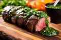 close-up of churrasco with chimichurri sauce on the side