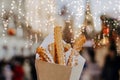 Close up churros on traditional Christmas fair in snow. Enjoying sweets on Xmas market. Winter holidays with family Royalty Free Stock Photo