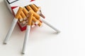 Close-up of cigarette box with filter cigarettes on white background