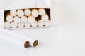 Close-up of cigarettes in pack on white background with copy spa Royalty Free Stock Photo