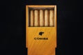 Close up of cigars Cohiba brands in open humidor box on black table in dark Royalty Free Stock Photo