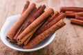 Close up of cinnamon in bowl on wooden background Royalty Free Stock Photo