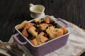 Close Up Cinnamon Bread and Butter Pudding with Raisins in Clear Baking Dish, Served with Vla Royalty Free Stock Photo