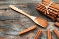 Close up cinnamon sticks and cinnamon powder in wooden spoon on wooden table background Royalty Free Stock Photo