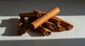 Close-up of Cinnamon Sticks with Dramatic Lighting and Shadows on White Surface Royalty Free Stock Photo