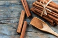 Close up cinnamon sticks and cinnamon powder in wooden spoon on wooden table background Royalty Free Stock Photo