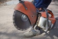 Close-up of a circular saw in the hands of a worker.