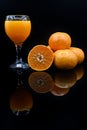 Close up, citrus fruit and a glass of fresh orange juice Royalty Free Stock Photo