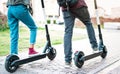 Close up of city commuters using electric scooter at urban park Royalty Free Stock Photo