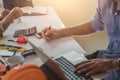 Close up of civil male engineer asian working on blueprint architectural project at construction site at desk in office Royalty Free Stock Photo