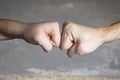 Close up clash of two fists on dramatic background