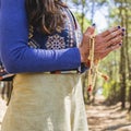 Close up of clasping hands holding a japa mala Royalty Free Stock Photo
