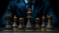 A close-up of a classic chess set with a focused player in a dark setting Royalty Free Stock Photo