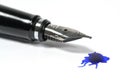 Close-up of a classic fountain pen with a blue ink blot on a white background, copy space, selected focus Royalty Free Stock Photo