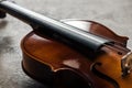 Close up of classical cello on grey textured background.