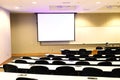 Close up on classroom, seat, table and projector screen Royalty Free Stock Photo