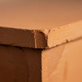 Close-up of a clay block with a chipped corner. The surface shows a textured, rough Royalty Free Stock Photo