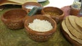 Close up of clay bowls with hot sauce an tortilla