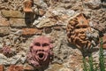 Close-up of clay masks attached to the wall in Colle di Val d`Elsa.