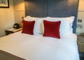 Clean luxury king size bed with many pillows in master hotel room Royalty Free Stock Photo