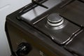 Close-up clean new kitchen gas stove cooker knob heat volume switch elegant metal steel black and white. Royalty Free Stock Photo