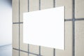 Close up of clean white underground banner on concrete tile wall on hallway background. Royalty Free Stock Photo