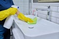 Close-up of cleaning sink with faucet in bathroom, hands in gloves with detergent Royalty Free Stock Photo