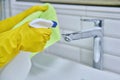 Close-up of cleaning sink with faucet in bathroom, hands in gloves with detergent Royalty Free Stock Photo