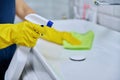 Close-up of cleaning sink with faucet in bathroom, hands in gloves with detergent Royalty Free Stock Photo