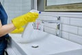 Close-up of cleaning sink with faucet in bathroom, hands in gloves with detergent Royalty Free Stock Photo