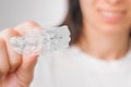 Close up of clear aligners in hand of woman. Orthodontic treatment for whitening and straightening teeth. Royalty Free Stock Photo