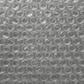Close-up of clear bubble wrap, showing a grid of air-filled plastic bubbles. The bubbles Royalty Free Stock Photo