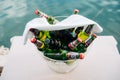 Perast, Montenegro - 03 august 2020: A close-up of a clear ice jar with full bottles of light and dark beer and a white