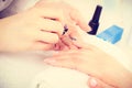 Close up of client and manicurist hands.