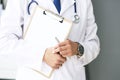 Close-up of clipboard with blank paper in medical doctor hand. Male doctor listens to the patient holding a clipboard Royalty Free Stock Photo