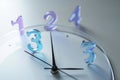 Close up of clock face with raised glass numbers showing time with hands pointing forward Royalty Free Stock Photo
