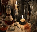 Close up with clock, key, candle, bottles and magic objects Royalty Free Stock Photo