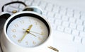 Close-up clock on laptop keyboard blurred background Royalty Free Stock Photo