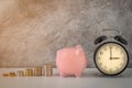 Close-up of clock and pink piggy bank with coins stack stair step up growing growth saving money. concept Business Finance Royalty Free Stock Photo