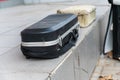 Close-up of a closed black violin case. An old, shabby container for a musical instrument lies on a gray tile outside the room Royalty Free Stock Photo