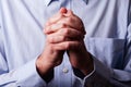 Close up or closeup of hands of faithful mature man praying