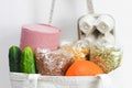 Close up cloth bag with eggs in box, buckwheat, oatmeal, pea, cucumbers, orange, pasta and toilet paper. Home food delivery Royalty Free Stock Photo