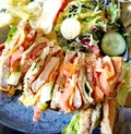 Close up of club sandwich containing chicken, bacon, bread and vegetables Royalty Free Stock Photo