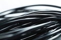 A close-up of a cluster of black electrical wires Royalty Free Stock Photo