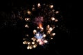 Close up of a cluster firework exploding and shooting off during a display