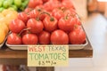 Cluster juicy tomatoes display at farmer market with price sign Royalty Free Stock Photo