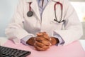 Close-up of clutched hands of female general practitioner Royalty Free Stock Photo