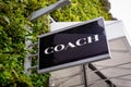 Close up of Coach American retail leather goods shop sign at Ashford Outlet Center, Kent, England. Royalty Free Stock Photo